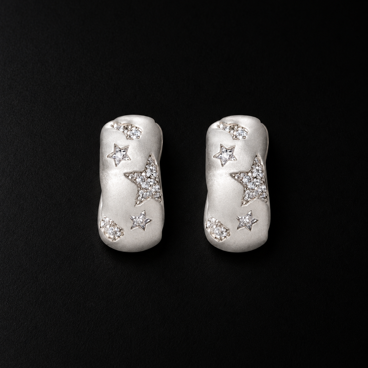 Lil Cacti star huggie earrings showing shape and finish on dark background