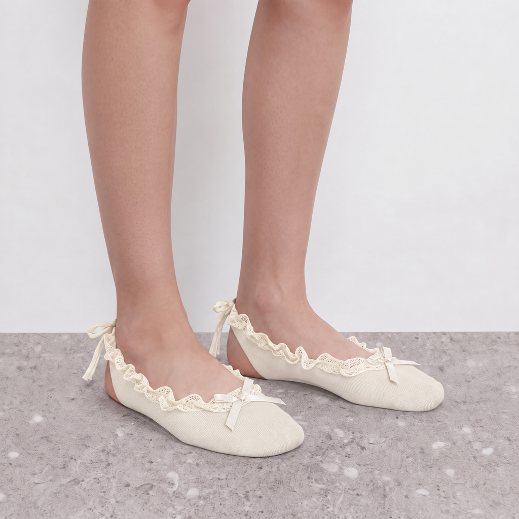 Model wearing cream ruffle ballet socks with ankle ribbon ties, close crop