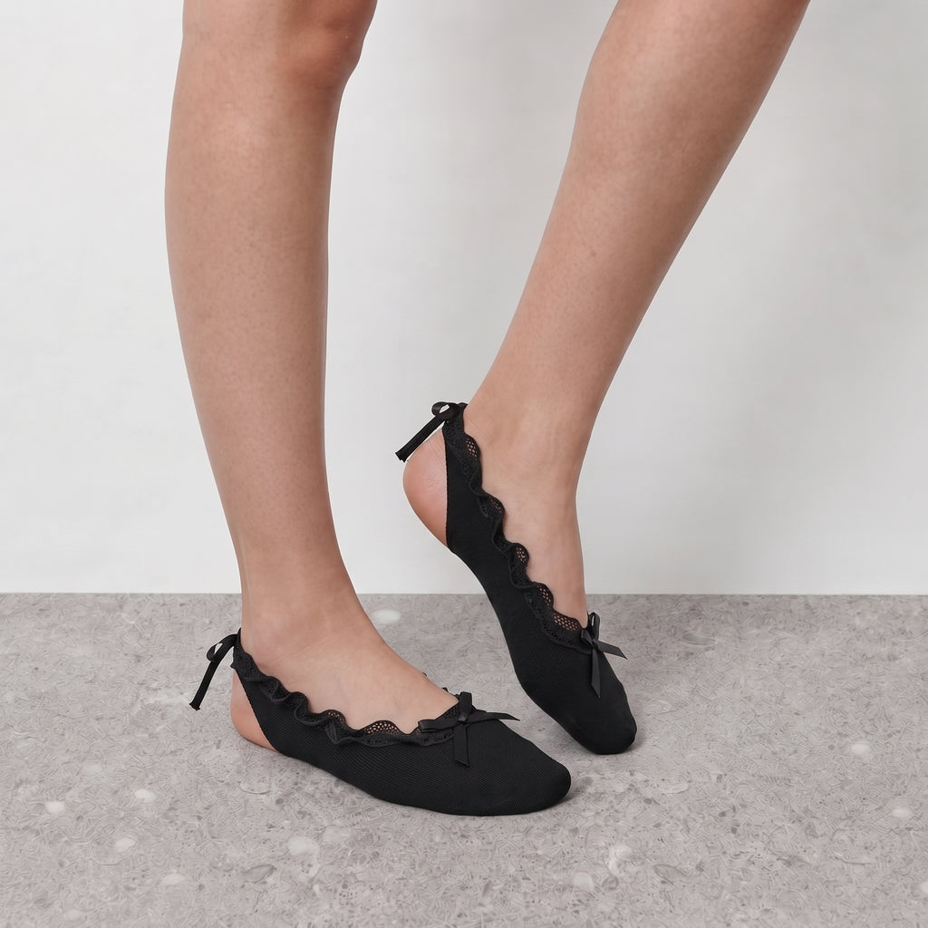 Black ruffle ballet socks worn barefoot with ribbon ankle ties and bow