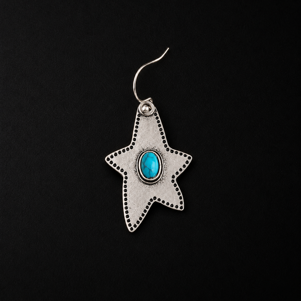 The Halcyon Western Star Earrings laid flat, a star earrings in full view
