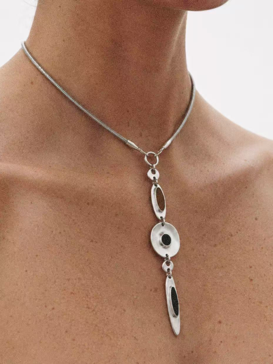 Model wearing the Halo Drop Collar Necklace seen from the side