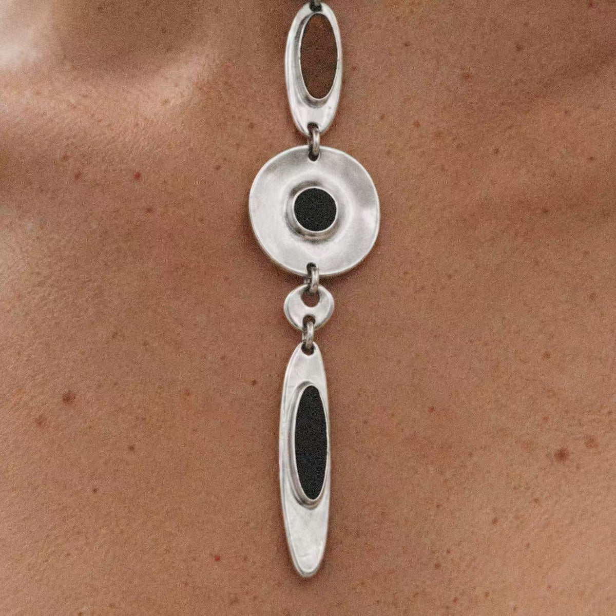 Model wearing the Halo Drop Collar Necklace in a close crop