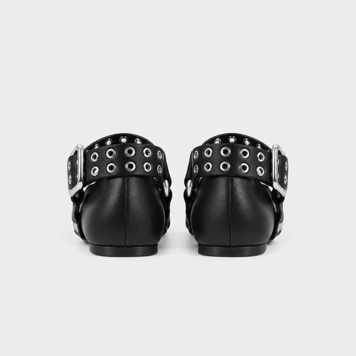 Back view of the black eyelet mary jane flats standing together