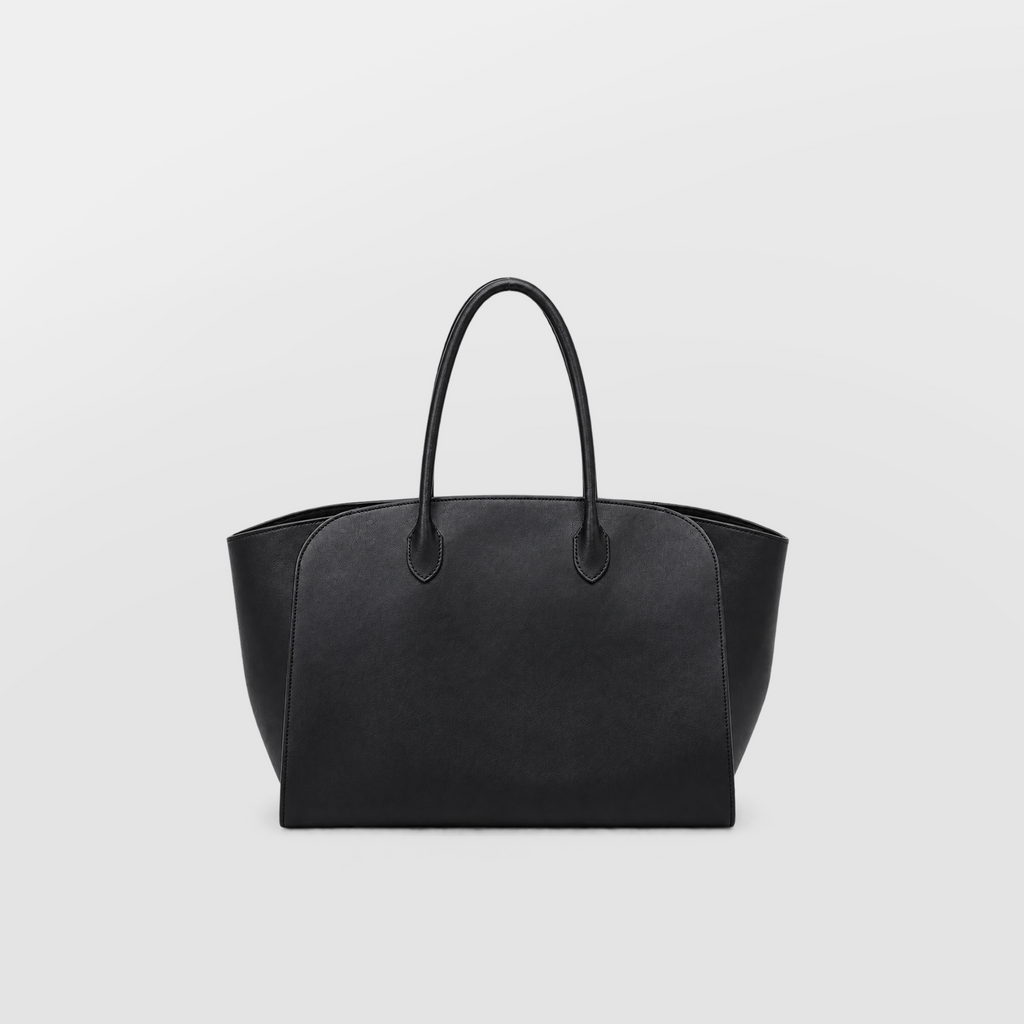 Model carrying a large black Lil Cacti leather tote over one shoulder