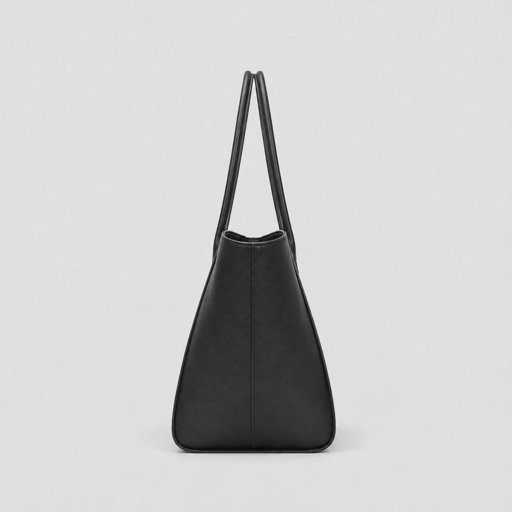 Front view of a black leather tote bag with long shoulder handles
