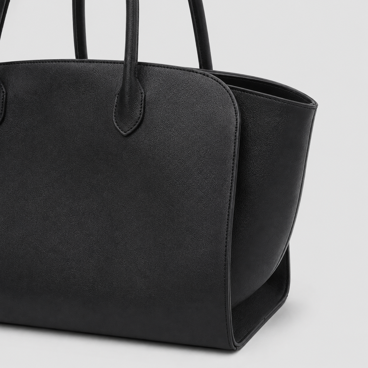 Interior view of the large black leather tote showing the open main compartment
