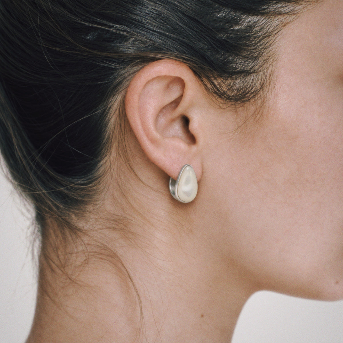 Model wearing Lil Cacti Lune Chunky Huggie Earrings, close crop on the detail