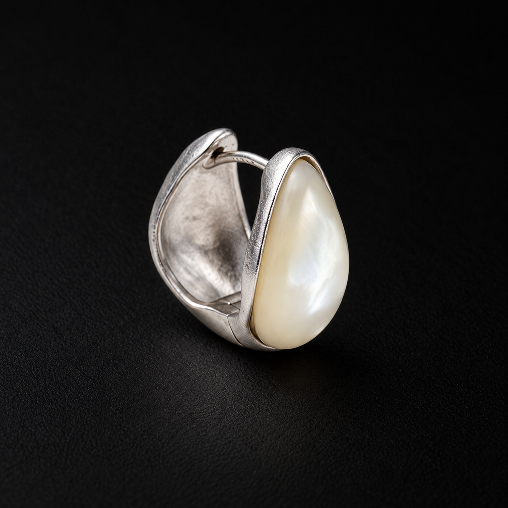 Detail view of the Lune Chunky Huggie Earrings