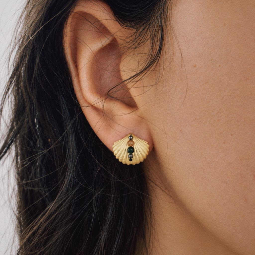 Model wearing Lil Cacti seashell stud earrings in a close detail view