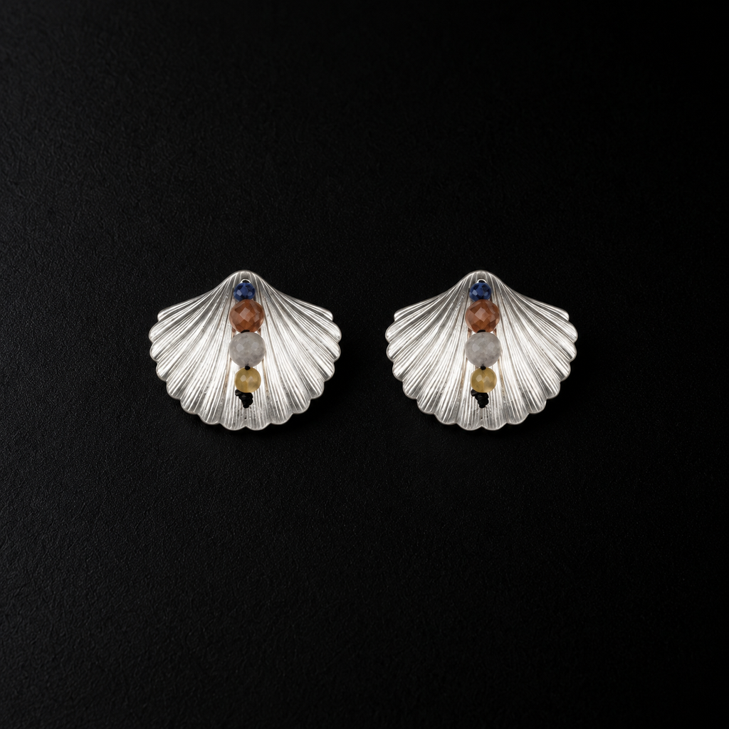 Lil Cacti seashell stud earrings showing shape and finish on dark background