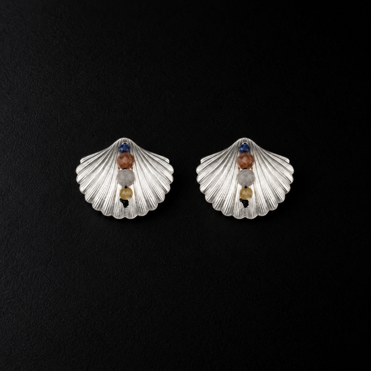 Lil Cacti seashell stud earrings showing shape and finish on dark background