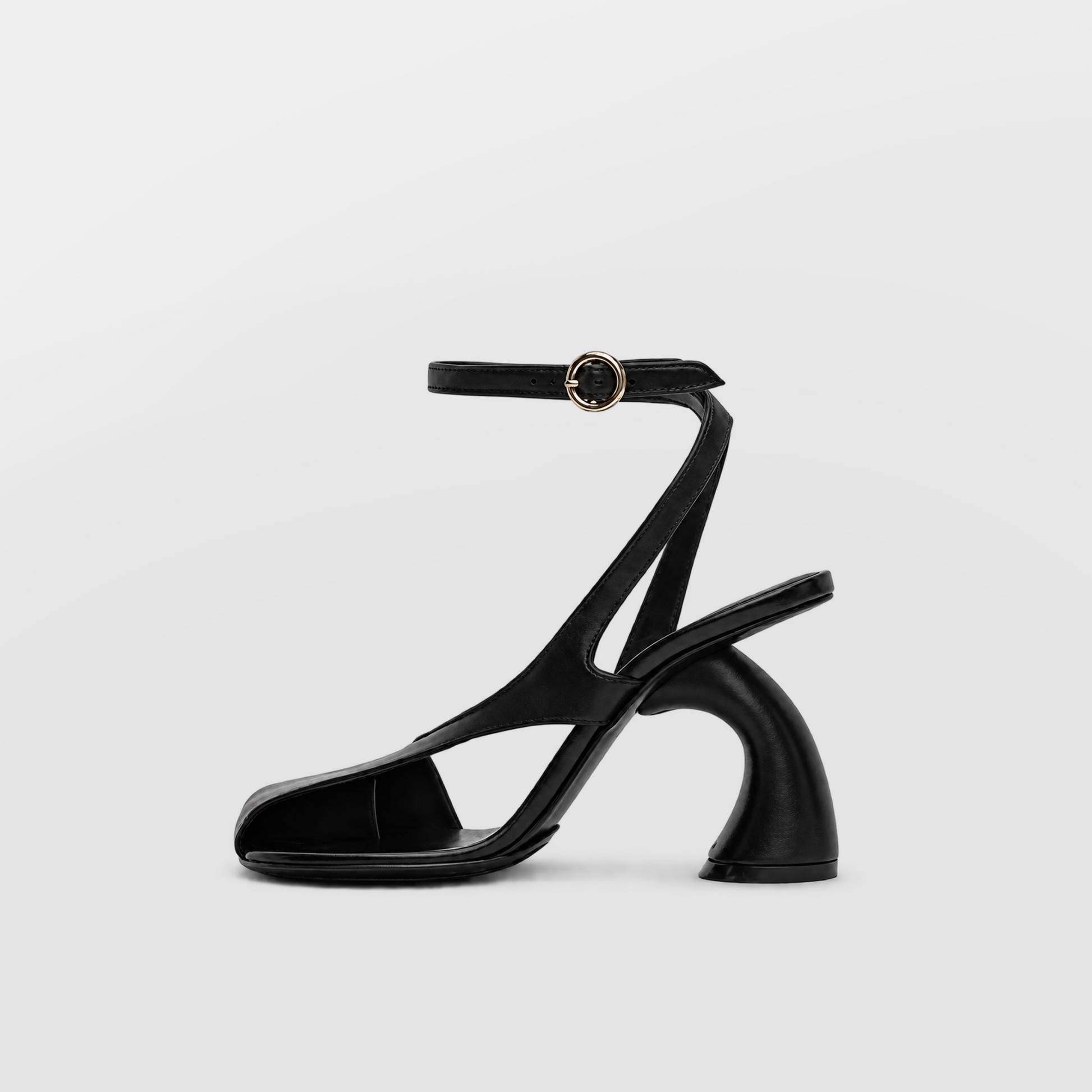 Nerissa Slingback Sandal Heels by Lil Cacti — side profile of one black shoe, sculpted curved heel and buckled ankle strap