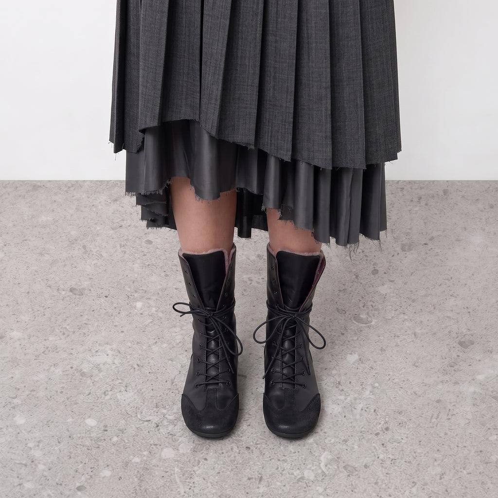 Ottilie lace-up combat boots on the model, both feet seen front on