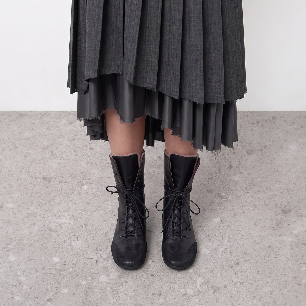 Ottilie lace-up combat boots on the model, both feet seen front on