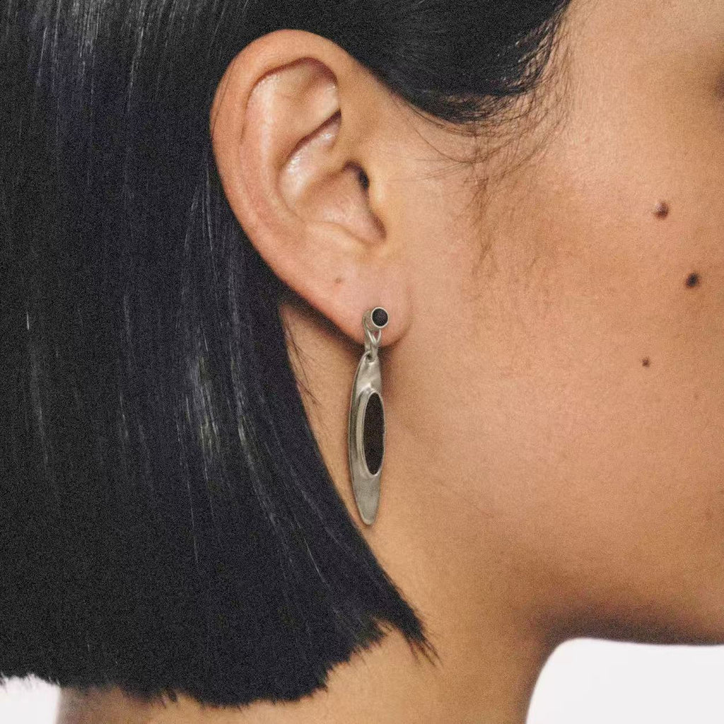 Model wearing the Oval Stone Drop Earrings seen from the front