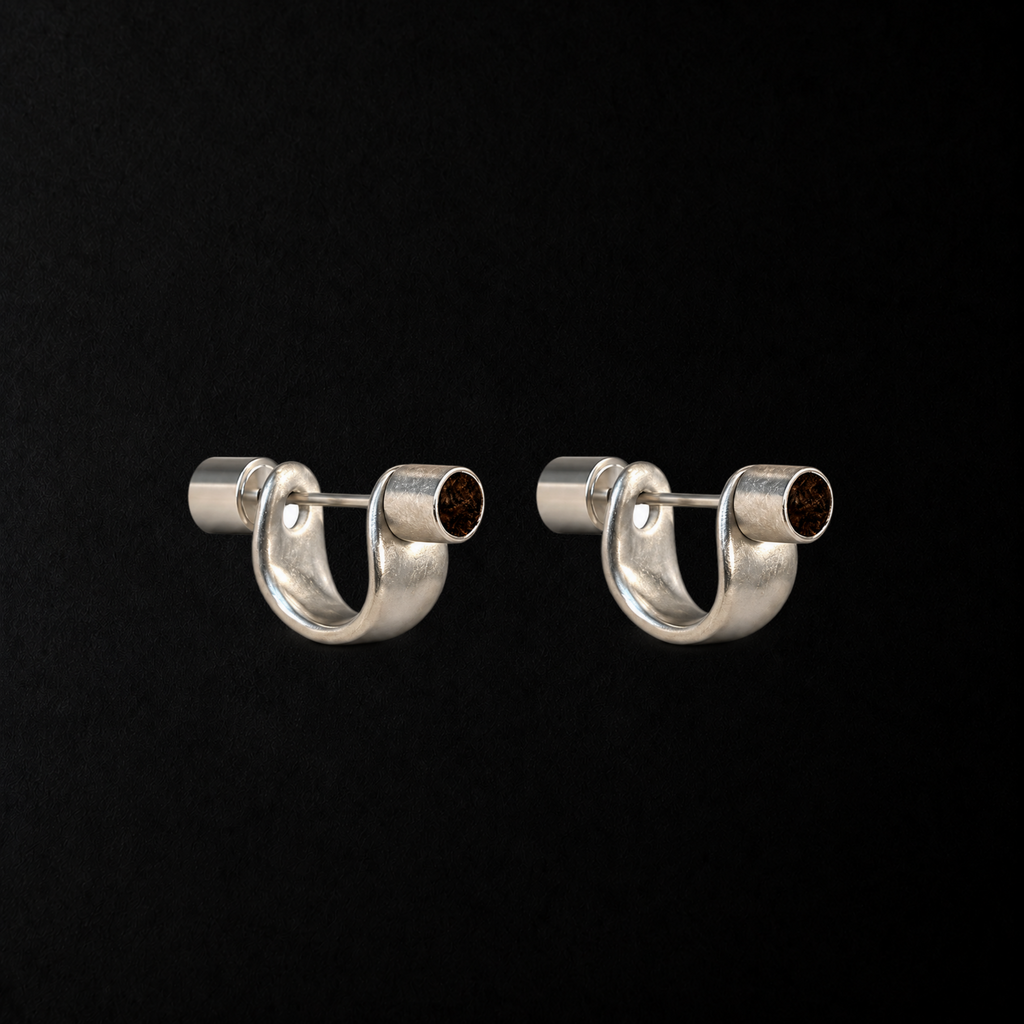 Pebble Disc Huggie Earrings product shot from the side on a plain studio background