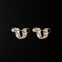 Pebble Disc Huggie Earrings product shot from the side on a plain studio background