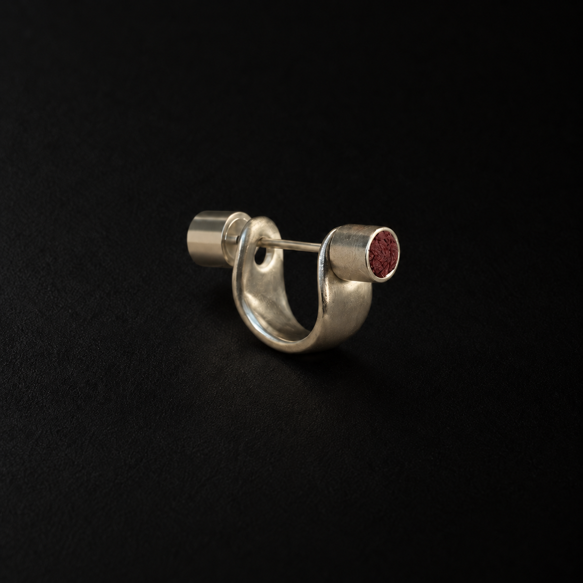 Pebble Disc Huggie Earrings shown at a three quarter angle in studio light