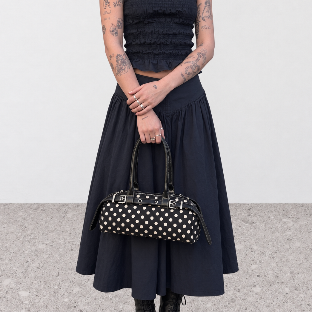 Model wearing the polka dot baguette bag over the shoulder