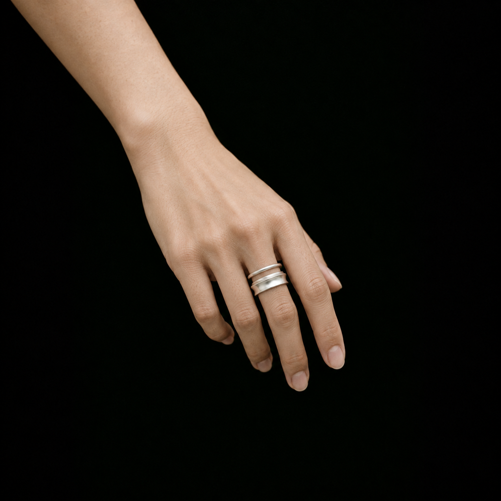 Model wearing the Ripple Band Ring in a relaxed pose