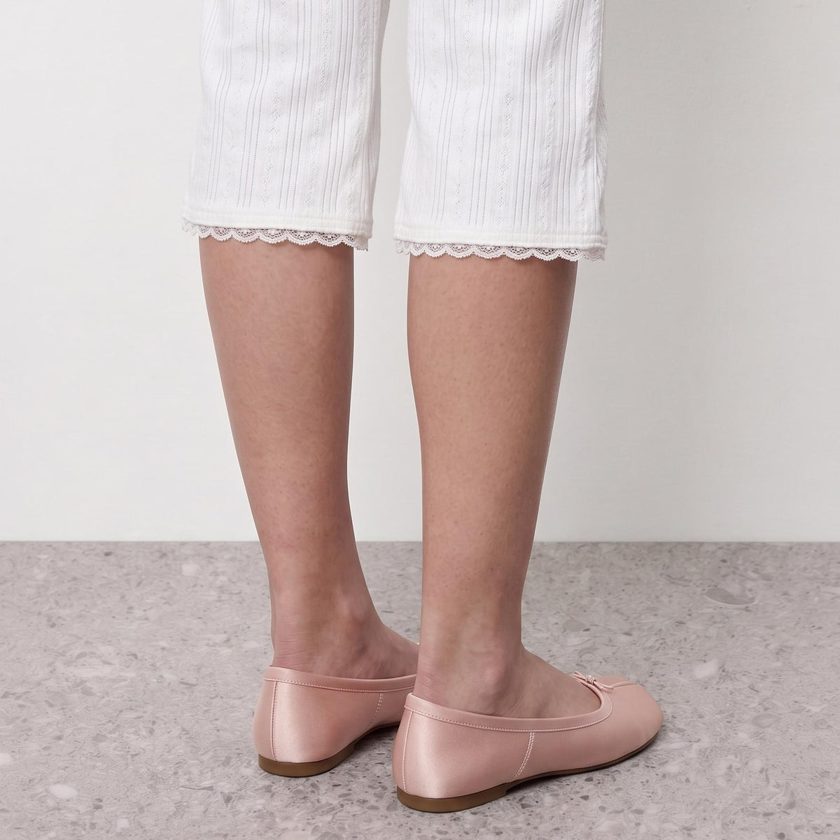 Model standing in Lil Cacti blush pink satin tabi ballet flats