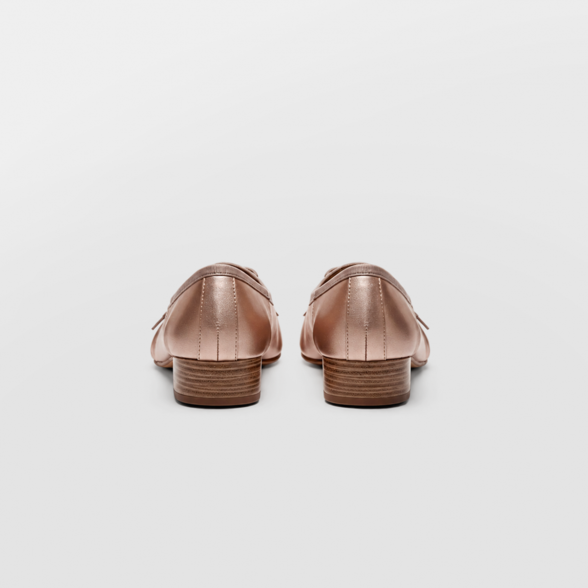 Back view of the champagne ballerina pumps showing the stacked wooden-look heel