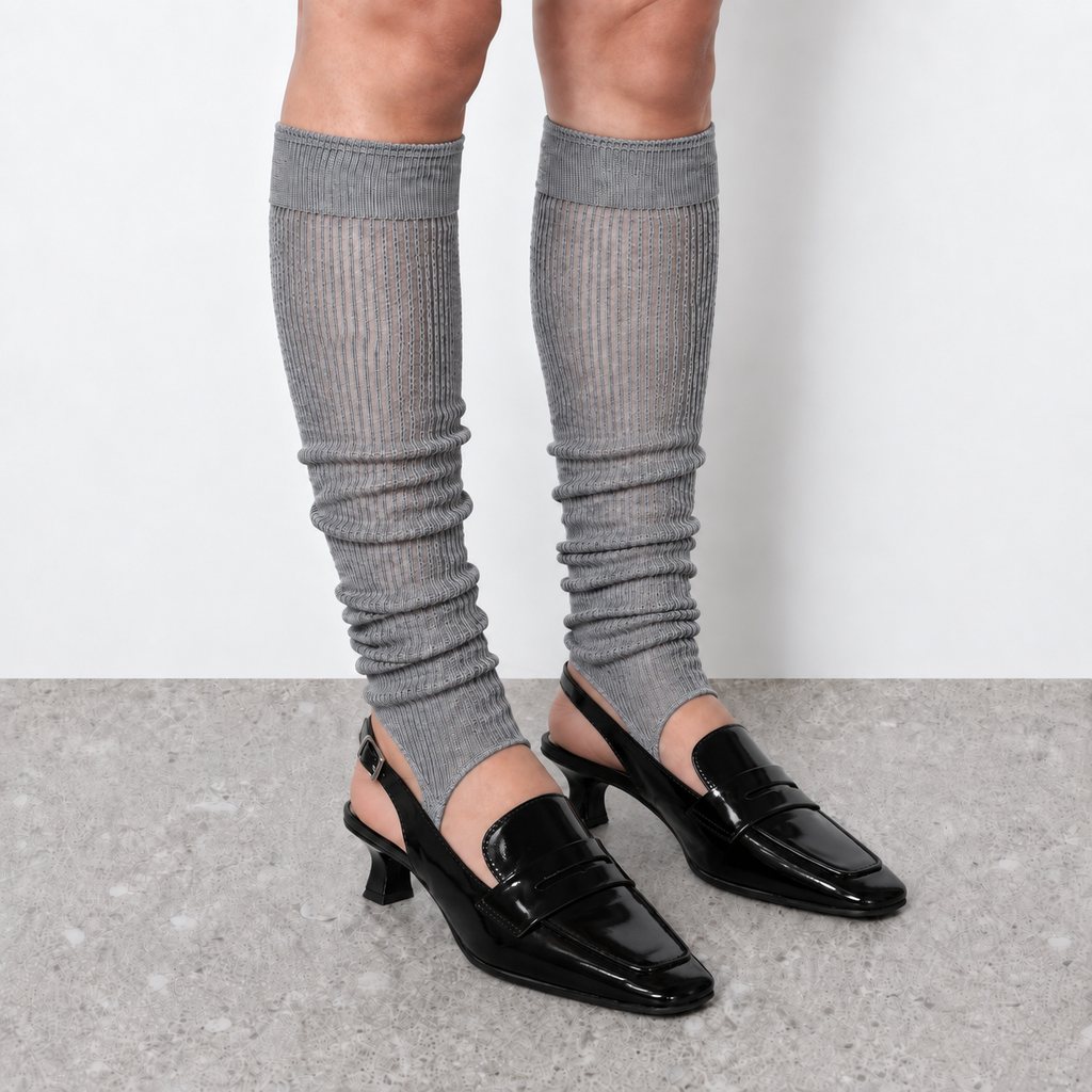 Model wearing grey ruched stirrup leg warmers over slingback heels seen from the front