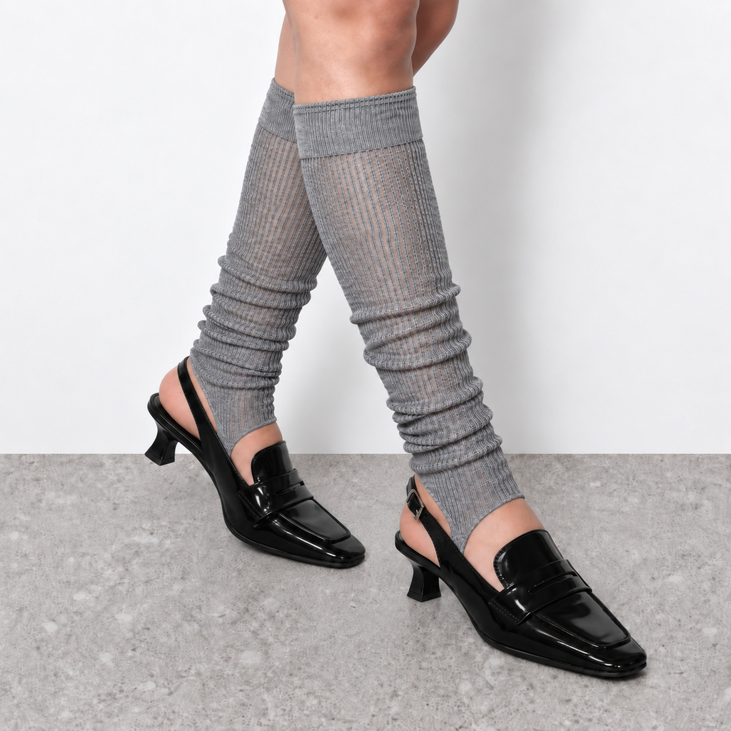 Model wearing grey ruched stirrup leg warmers over slingback heels seen from behind