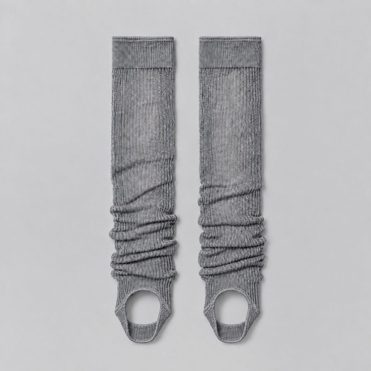 grey ruched stirrup leg warmers laid flat on a pale background