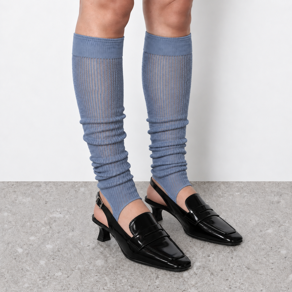 Model wearing haze blue ruched stirrup leg warmers over slingback heels seen from the front