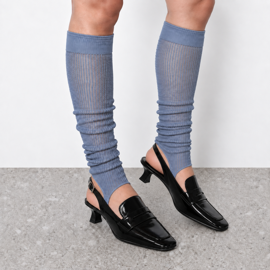 Model wearing haze blue ruched stirrup leg warmers over slingback heels seen from the side