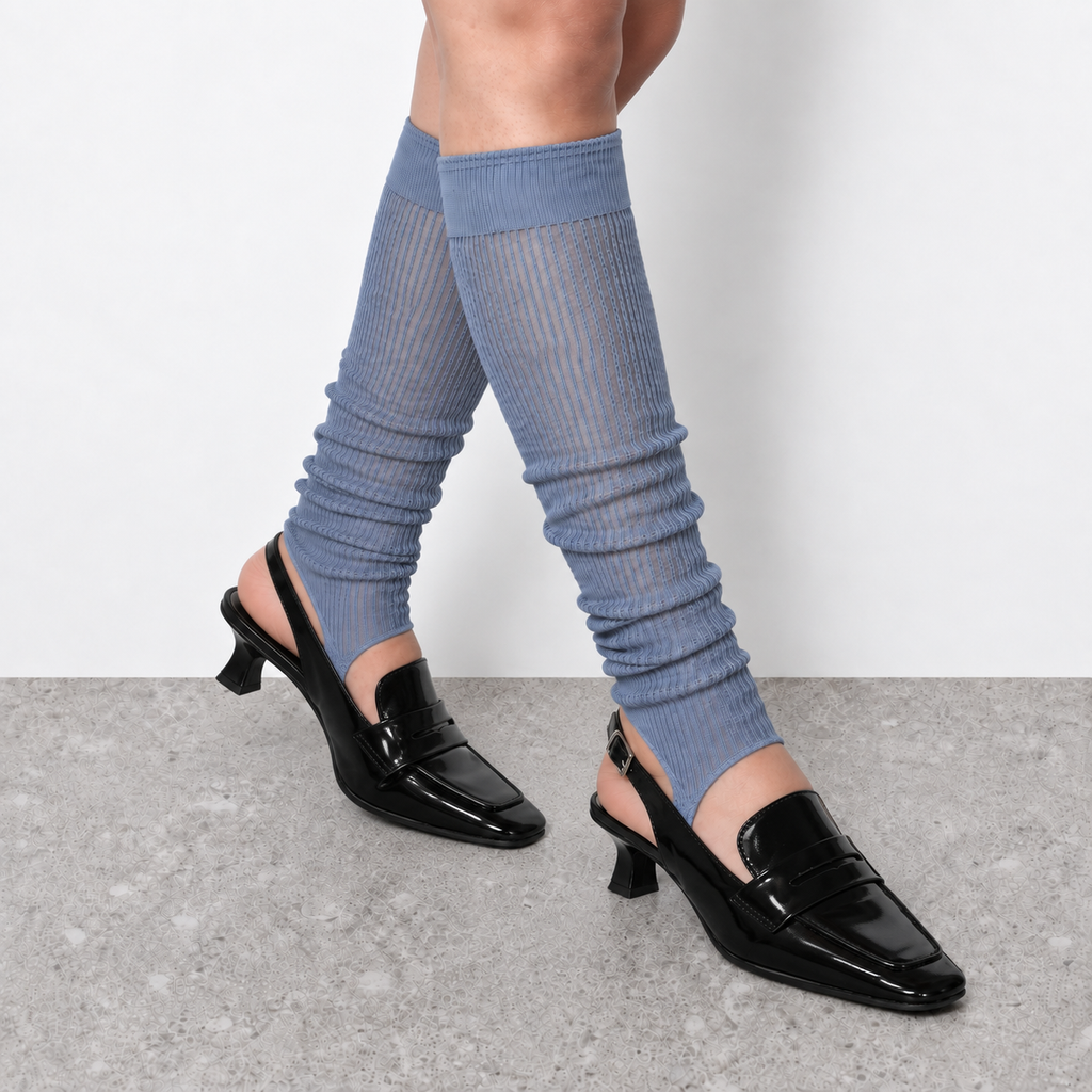 Model wearing haze blue ruched stirrup leg warmers over slingback heels seen from behind