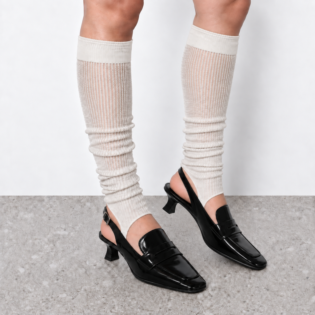 Model wearing white ruched stirrup leg warmers over slingback heels seen from behind