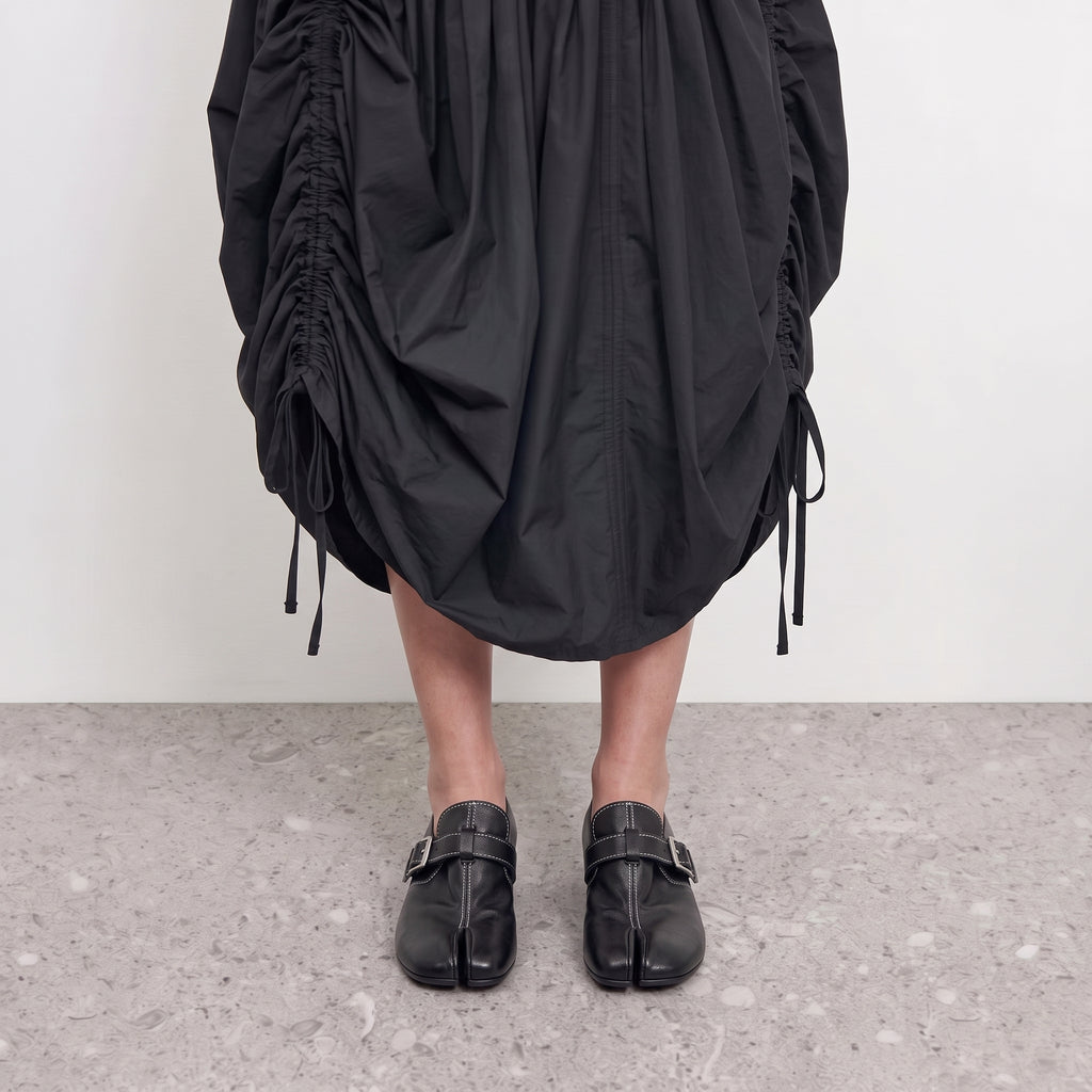 Front view on the foot of black tabi loafers showing the divided toe