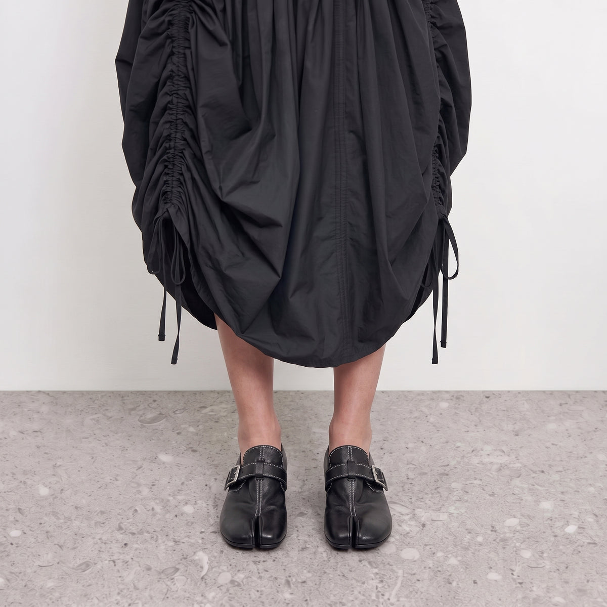 Front view on the foot of black tabi loafers showing the divided toe
