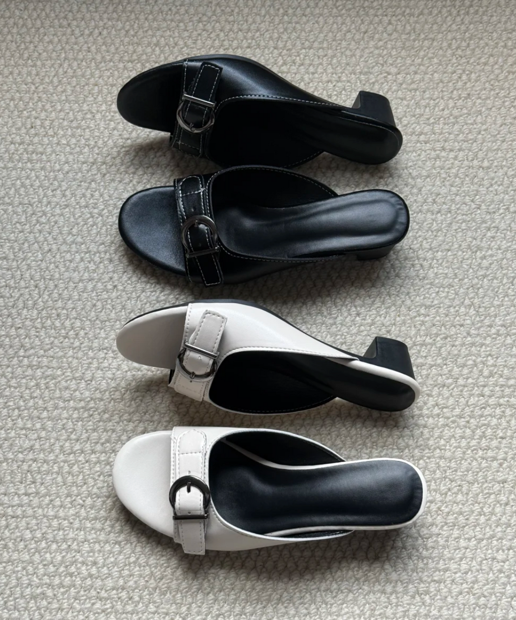 Side profile of Belvra black buckle mule heels showing heel height and backless design