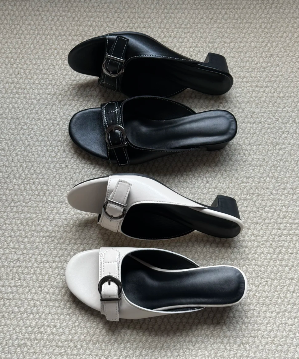 Side profile of Belvra black buckle mule heels showing heel height and backless design