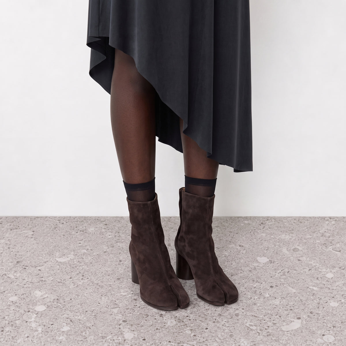 Model wearing the Sena Vegan Suede Tabi Ankle Boots seen from the side
