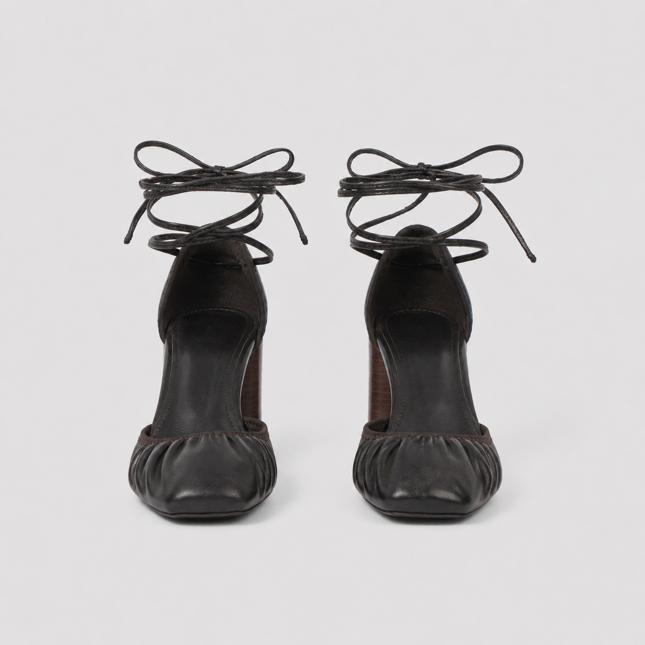 Angled view of brown tie up heels showing the low vamp and heel height