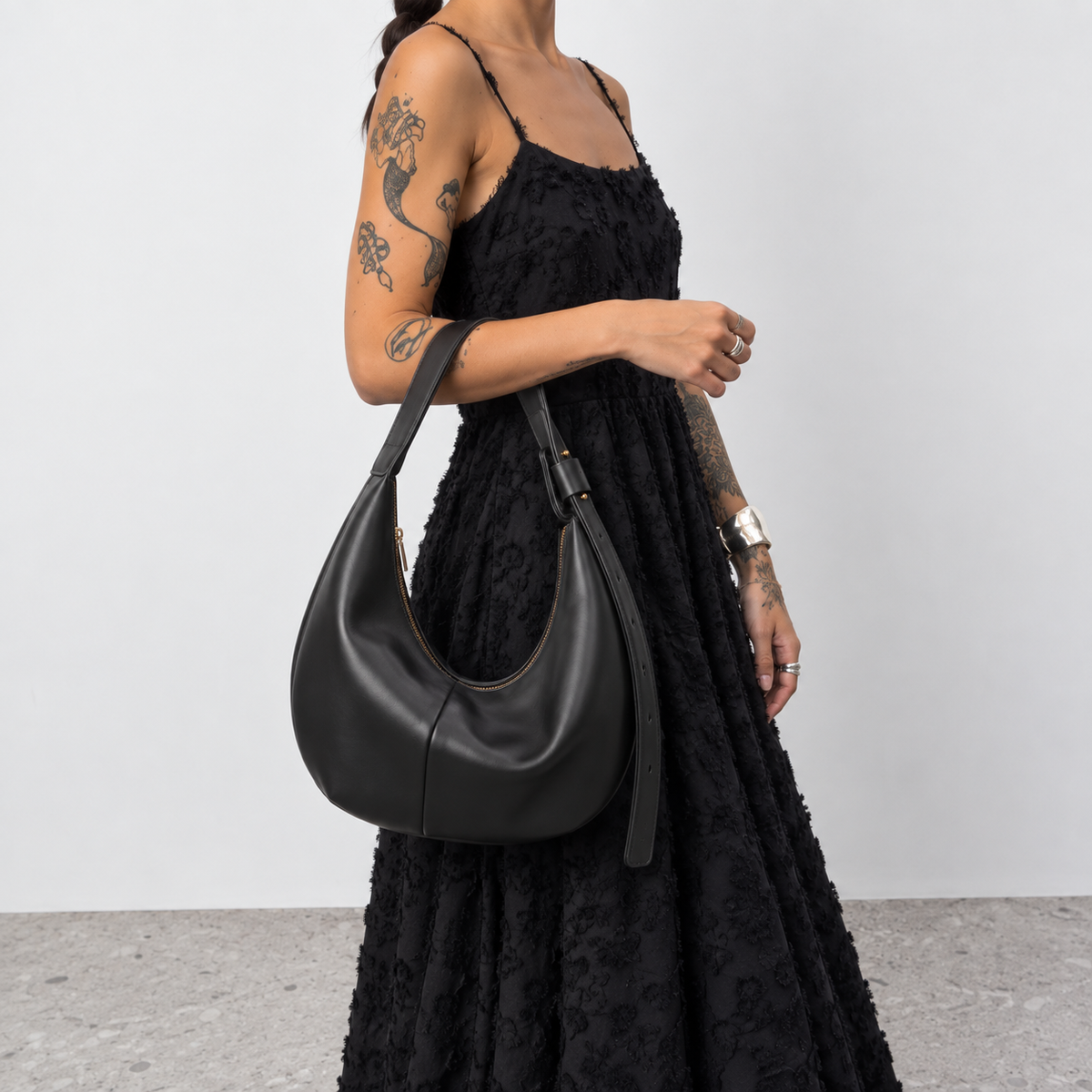 Full length shot of a model carrying the Lil Cacti crescent shoulder bag