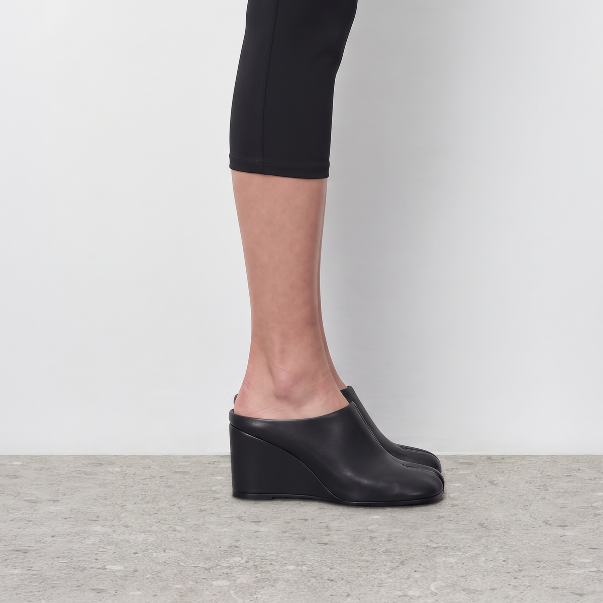 Model wearing Solene Tabi Wedge Slides by Lil Cacti, view 1