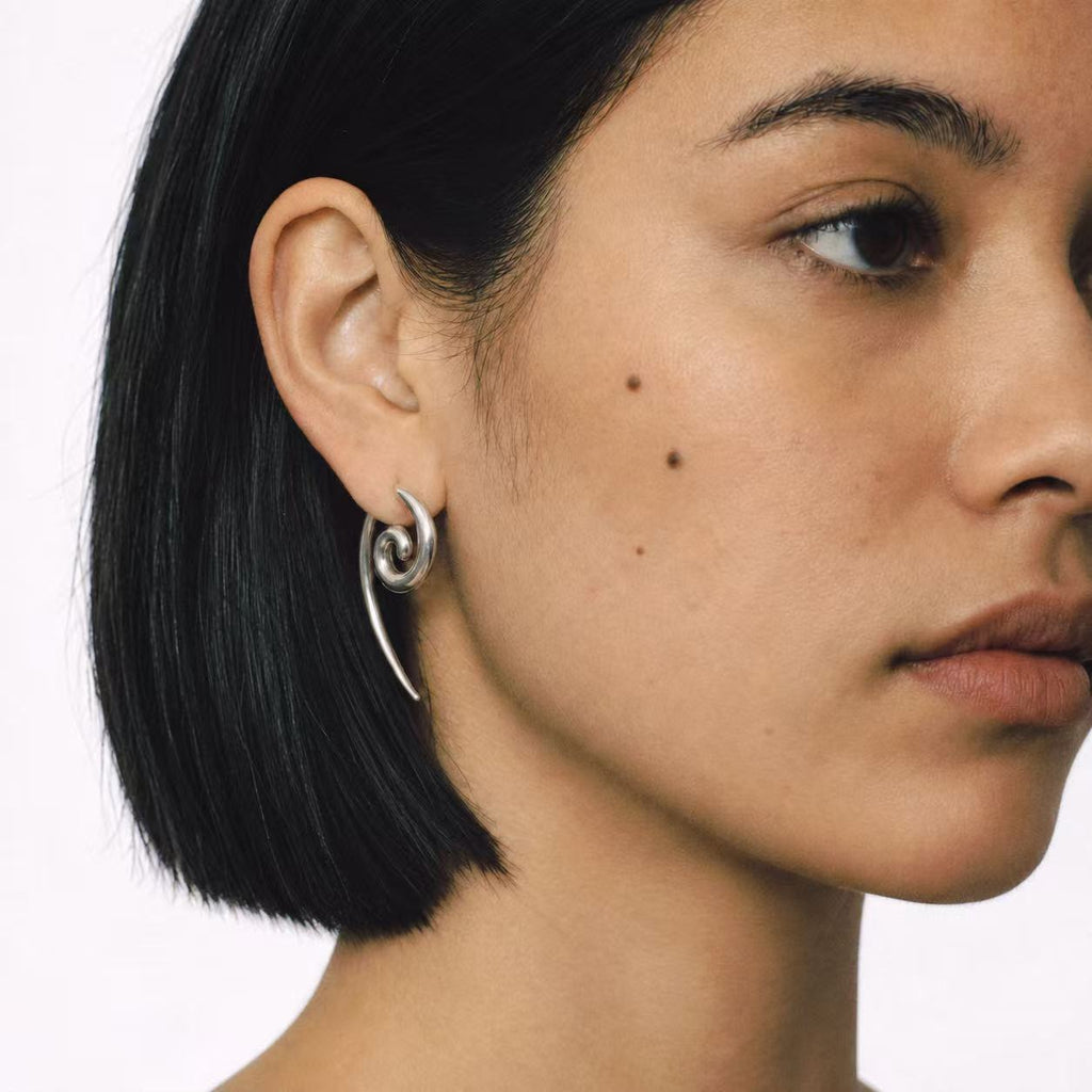 Model wearing the Spiral Coil Drop Earrings seen from behind