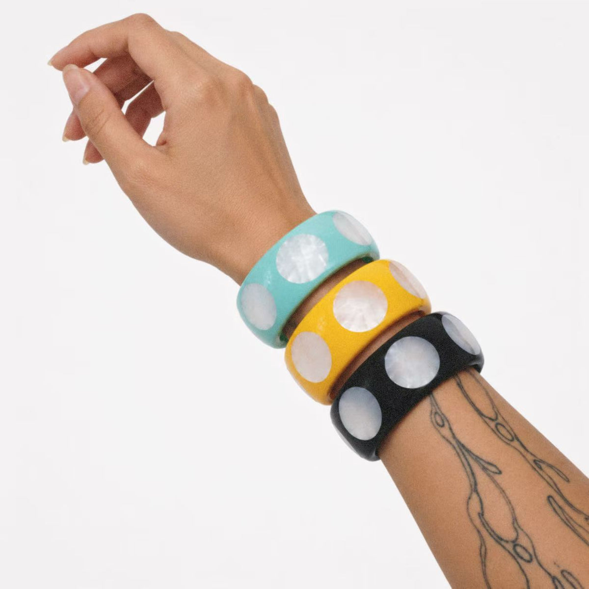 Model wearing the Spotted Chunky Bangle in a relaxed pose