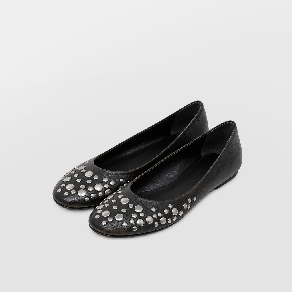 Angled view of both black ballet flats showing round toe and scattered stud placement