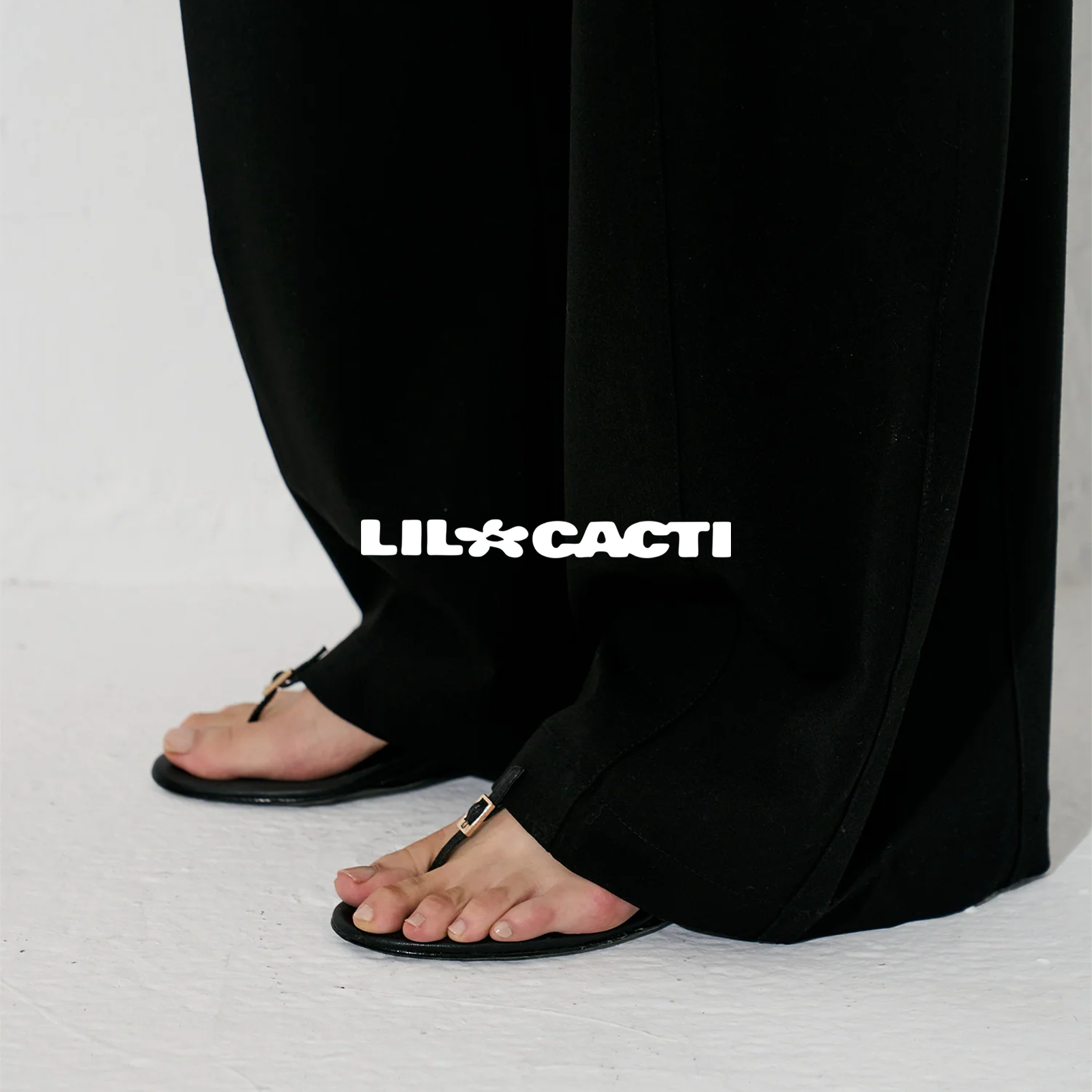 Strappy sandals in black leather — slim double strap over sculptural wedge by lil cacti