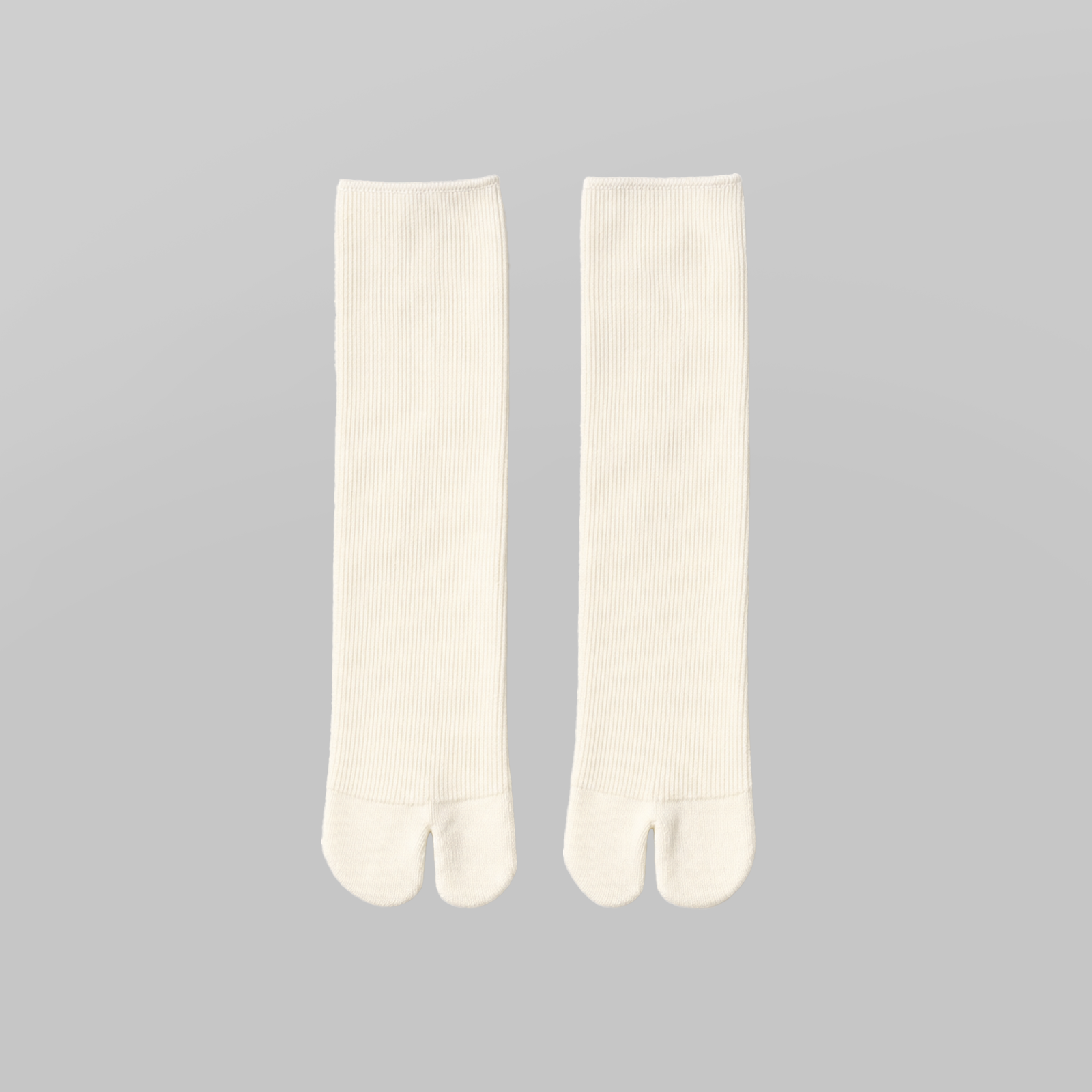 Mid Calf Tabi Socks by Lil Cacti — milky white ribbed knit pair laid flat side by side, split toe visible