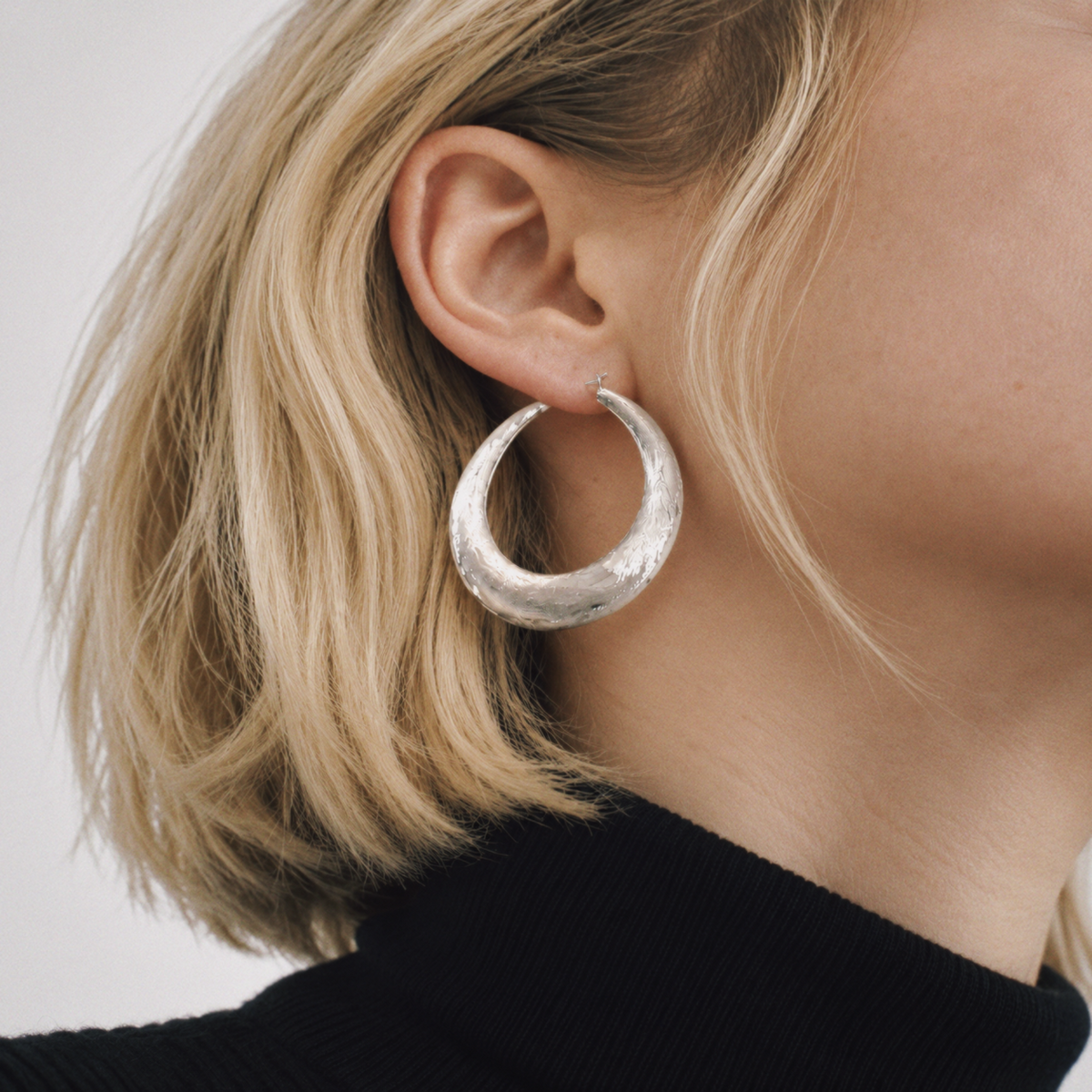 Model wearing Tide Hammered Hoop Earrings by Lil Cacti, view 4