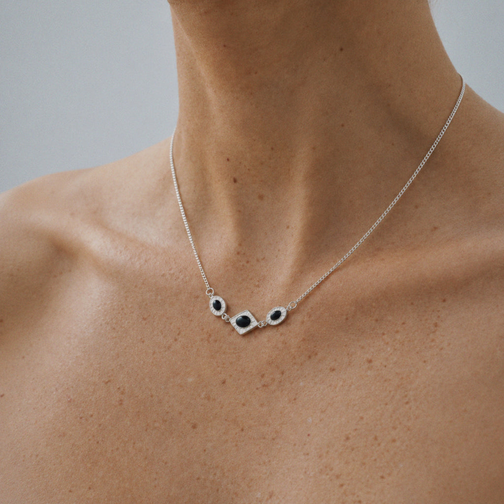 Model wearing the Triad Art Deco Station Necklace, three quarter view