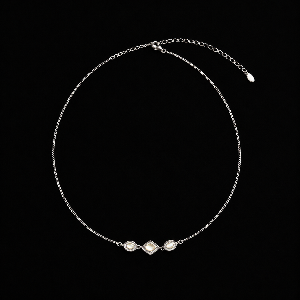Pair of Triad Art Deco Station Necklace angled together on a dark background