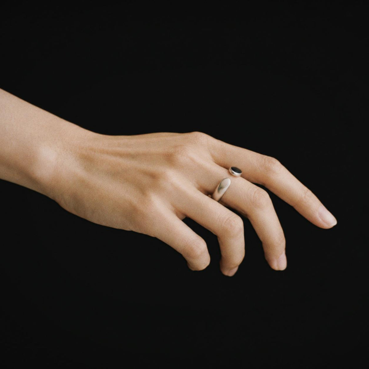 Model wearing the Umbra Oval Signet Ring, three quarter view